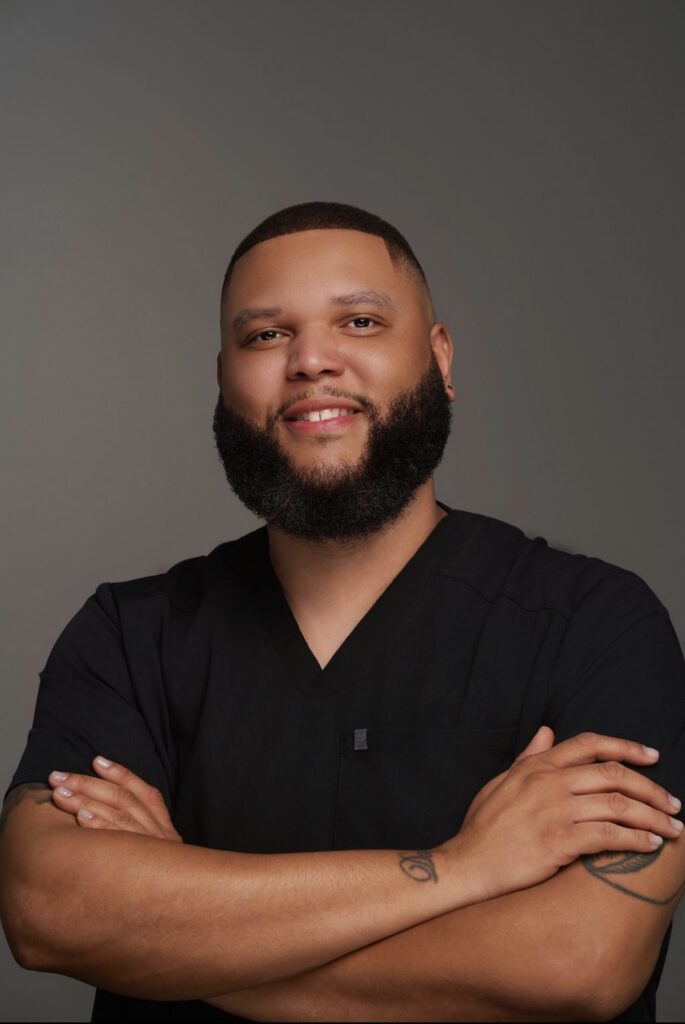 Home Man in black scrub smiling